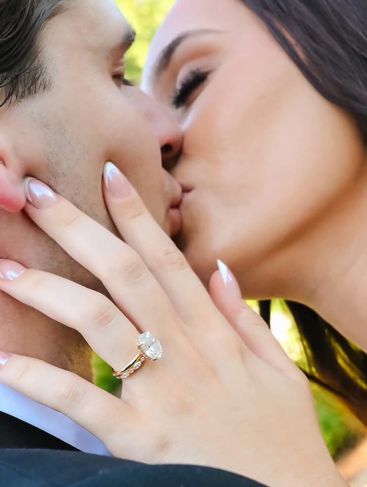 An engaged couple sharing a tender moment in golden autumn light